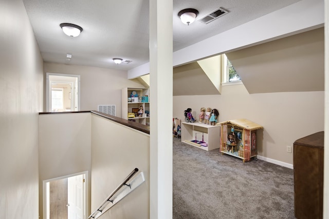 interior space featuring lofted ceiling and carpet flooring