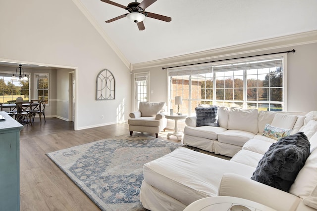 living room with ceiling fan, high vaulted ceiling, a wealth of natural light, and wood-type flooring