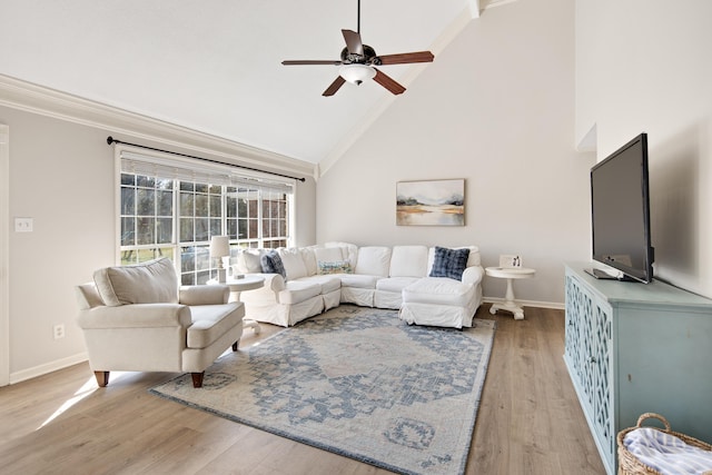 living room featuring high vaulted ceiling, light wood-type flooring, ceiling fan, and crown molding