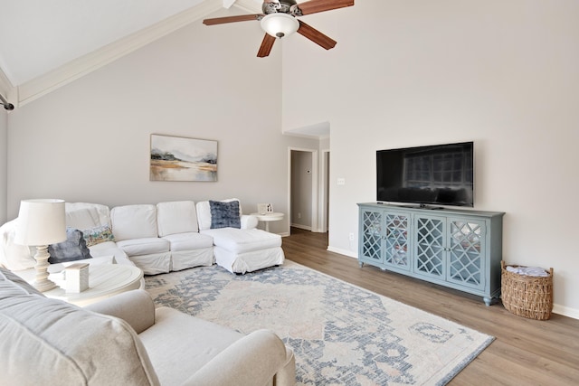 living room with ornamental molding, high vaulted ceiling, ceiling fan, and hardwood / wood-style floors