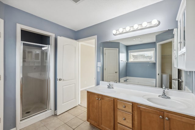 bathroom featuring tile patterned flooring, separate shower and tub, and vanity