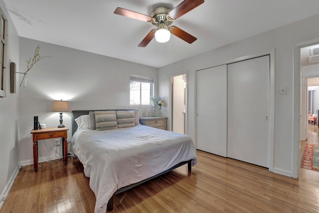 bedroom with a closet, ceiling fan, and light hardwood / wood-style flooring