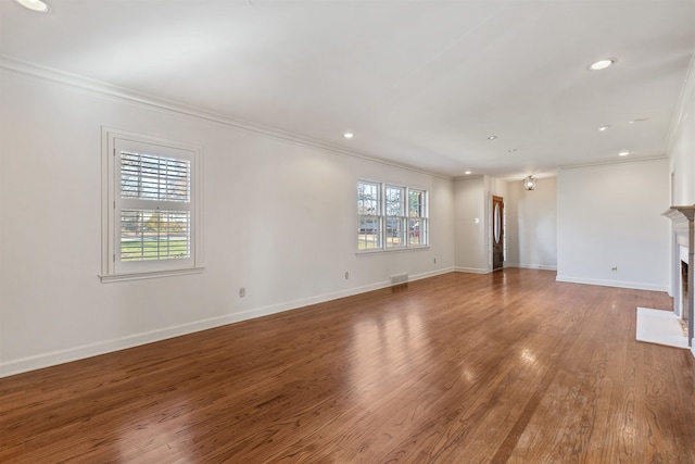 unfurnished living room featuring a healthy amount of sunlight and crown molding