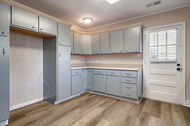 kitchen featuring light hardwood / wood-style floors, crown molding, and gray cabinets