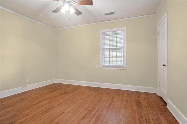 spare room with ceiling fan, hardwood / wood-style flooring, and crown molding