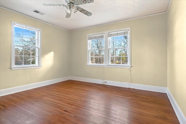 spare room with hardwood / wood-style flooring, ceiling fan, crown molding, and plenty of natural light