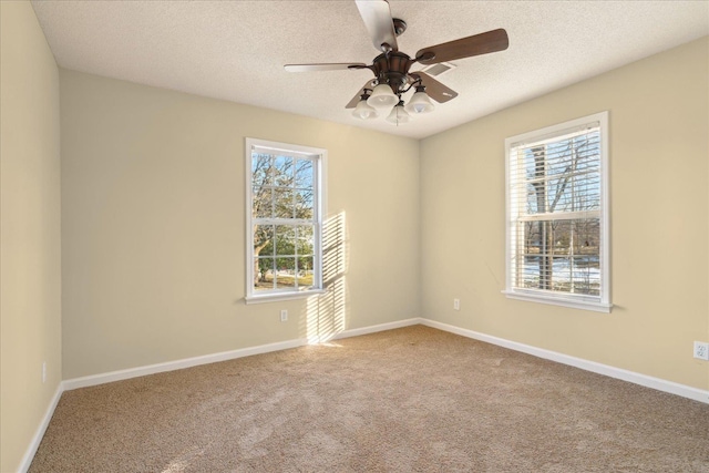 carpeted empty room featuring a textured ceiling and ceiling fan