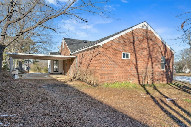 back of house with a carport