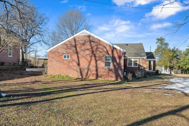 view of side of home with a yard