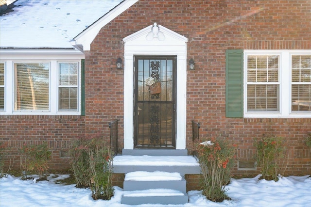 view of snow covered property entrance