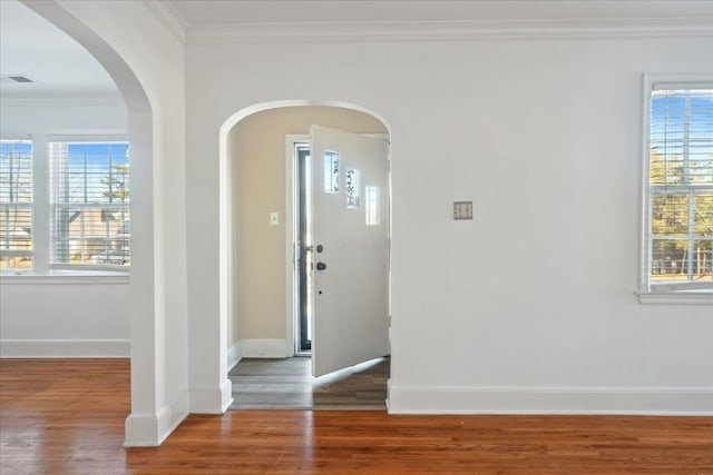 foyer entrance featuring ornamental molding and hardwood / wood-style floors