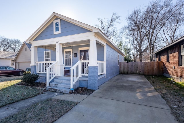 bungalow-style house featuring a porch and a garage