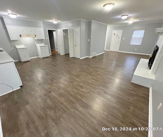 unfurnished living room featuring dark hardwood / wood-style flooring and a fireplace