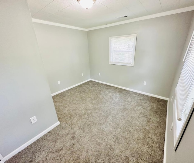 carpeted spare room with crown molding