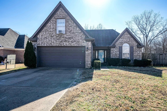 view of property featuring a garage and a front yard