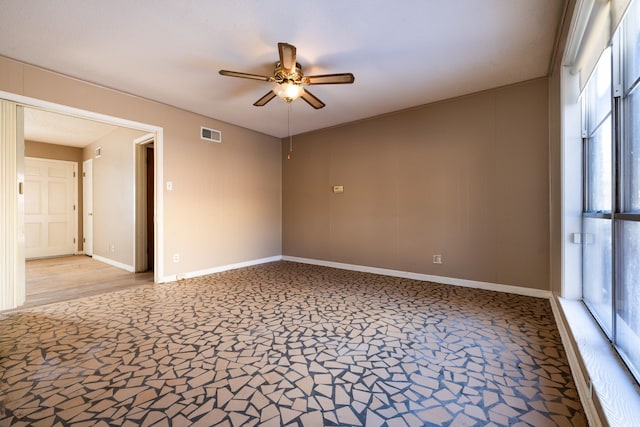 unfurnished room with ceiling fan