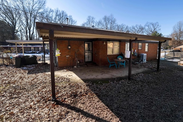 back of house featuring central AC unit