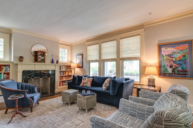 living room with a high end fireplace, crown molding, and hardwood / wood-style flooring