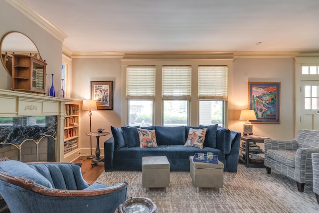 living room with hardwood / wood-style flooring, ornamental molding, and a fireplace