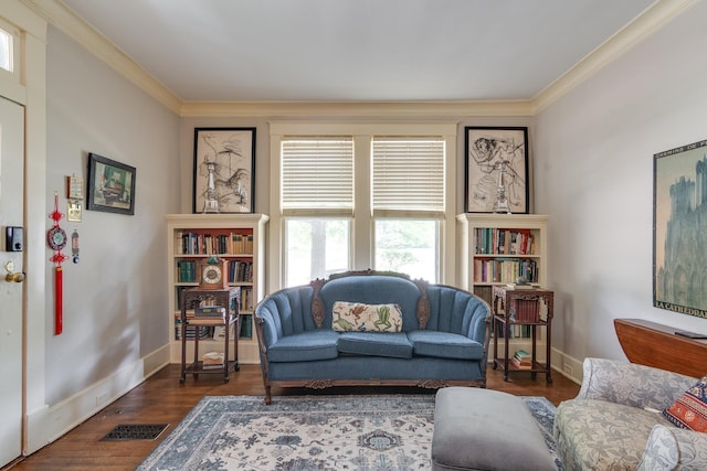 living room with dark hardwood / wood-style flooring and crown molding