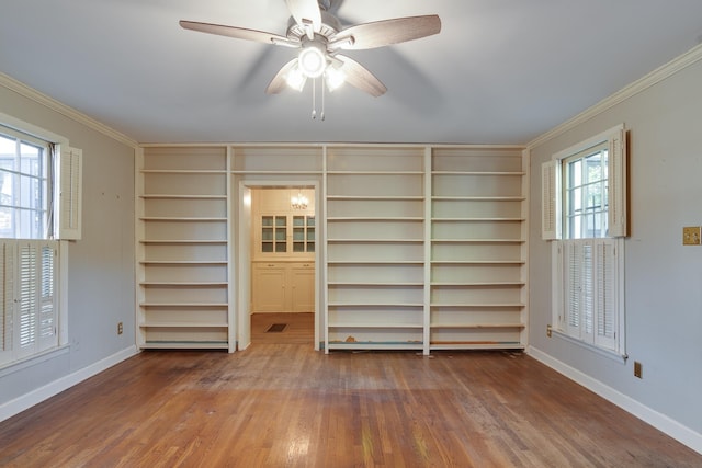 interior space with ceiling fan, hardwood / wood-style flooring, crown molding, and built in features