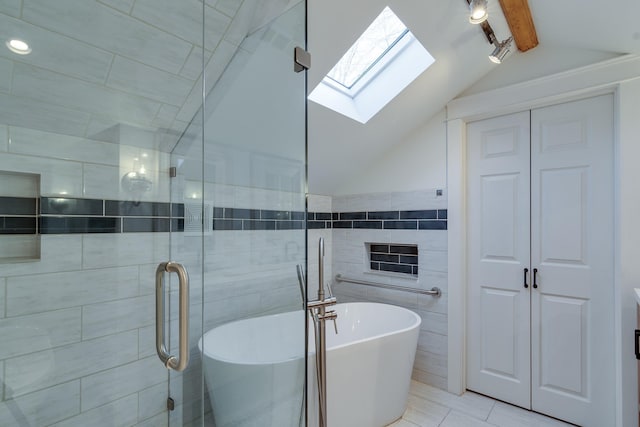 bathroom with tile walls, separate shower and tub, lofted ceiling with skylight, and tile patterned floors