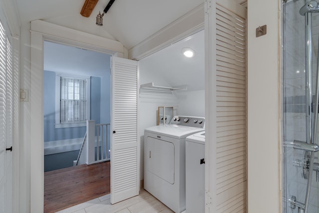 washroom featuring washing machine and clothes dryer and light tile patterned floors