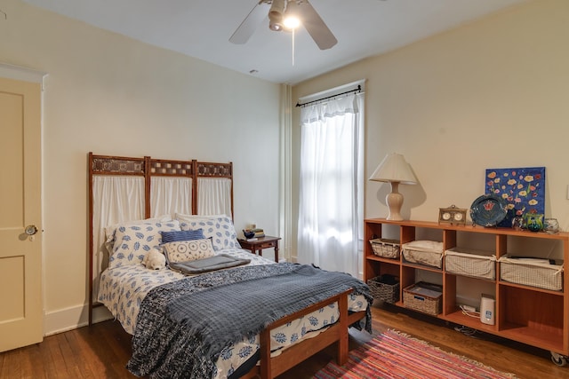 bedroom featuring ceiling fan and dark wood-type flooring