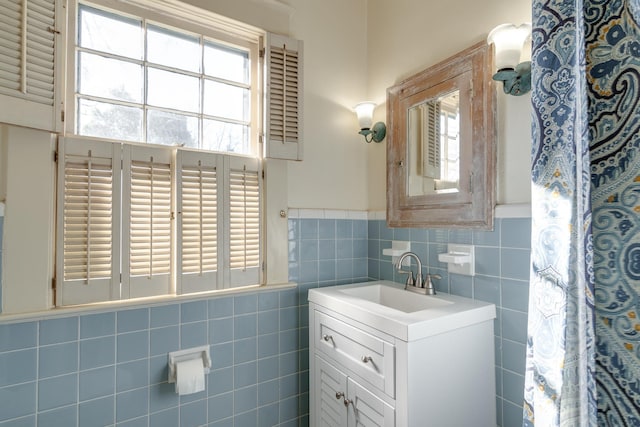 bathroom with tile walls and vanity