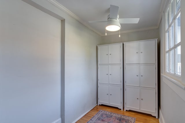 unfurnished bedroom featuring ceiling fan, crown molding, light hardwood / wood-style flooring, and multiple windows