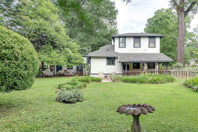 rear view of house with a lawn