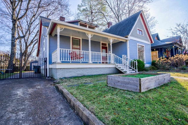 view of front of property with a porch and a front lawn