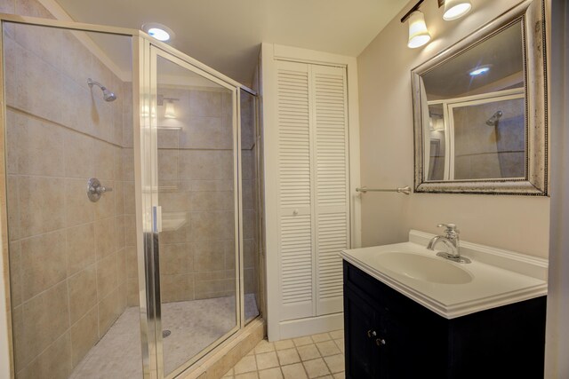 bathroom featuring an enclosed shower, tile patterned floors, and vanity