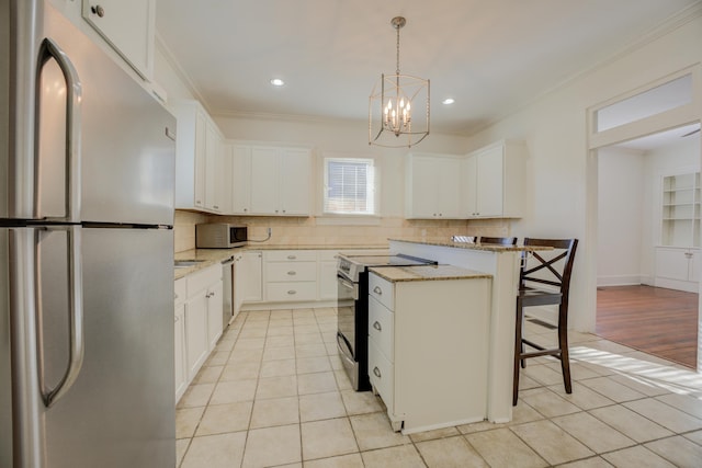 kitchen with a kitchen island, stainless steel appliances, a breakfast bar, and white cabinets