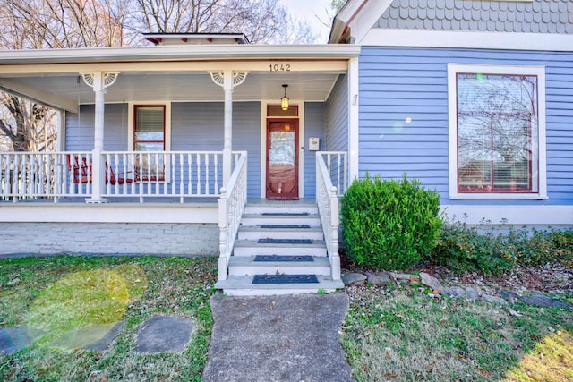 view of exterior entry with a porch