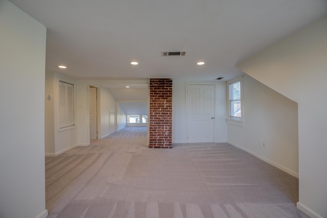 corridor with light carpet and lofted ceiling