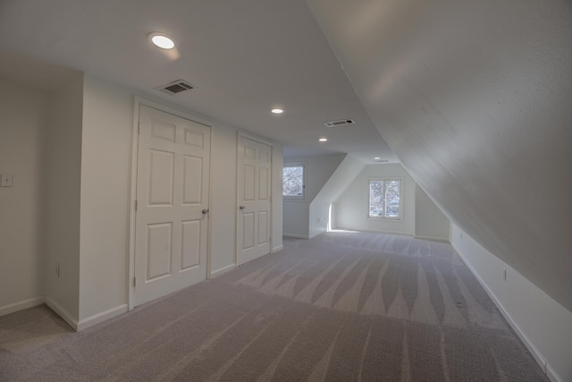 bonus room featuring lofted ceiling and carpet flooring