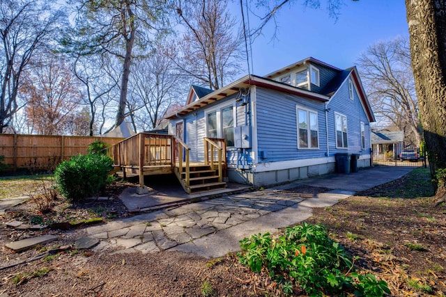 rear view of house featuring a deck and a patio area