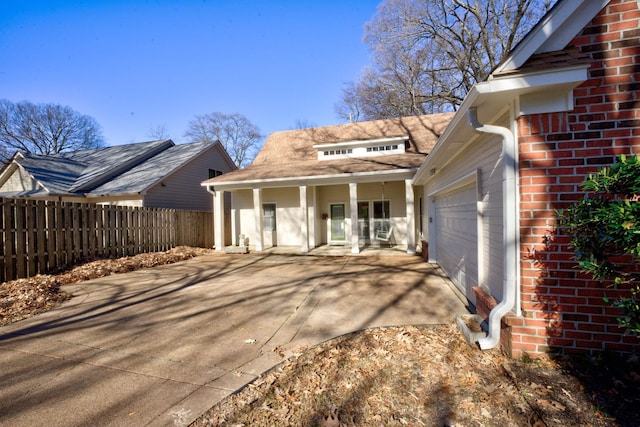 view of property exterior featuring covered porch and a garage