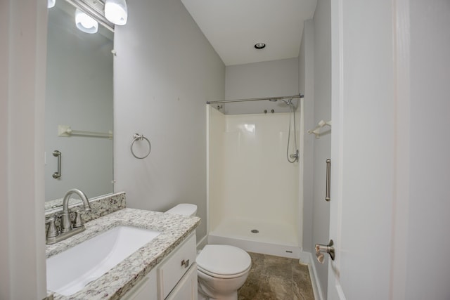 bathroom with toilet, vanity, and walk in shower