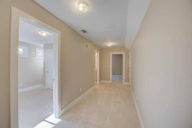 hallway featuring light carpet