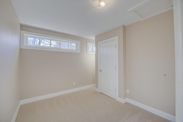 basement featuring light carpet