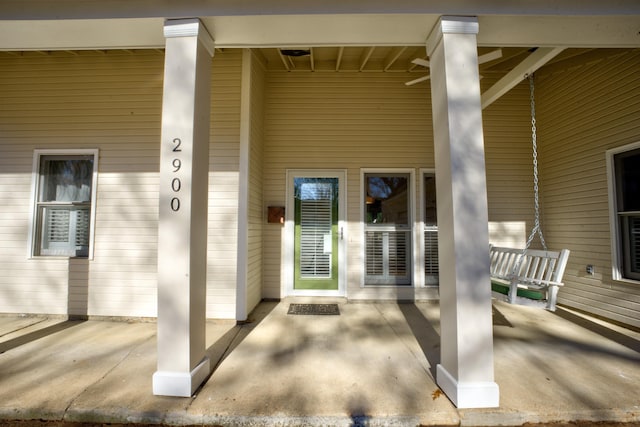 entrance to property featuring a porch