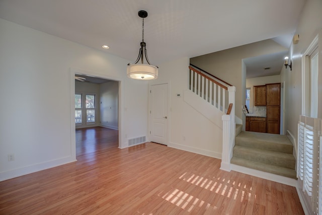 entryway with ceiling fan and light hardwood / wood-style floors