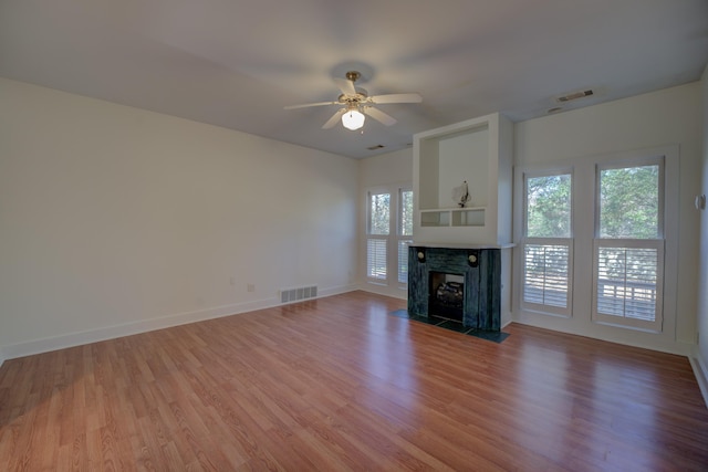 unfurnished living room with hardwood / wood-style flooring and ceiling fan