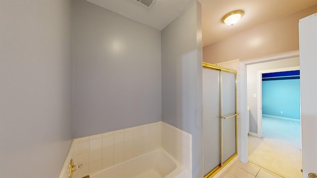 full bathroom with a stall shower, a garden tub, visible vents, and baseboards