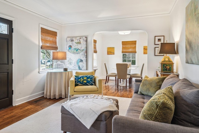 living room with hardwood / wood-style flooring and ornamental molding