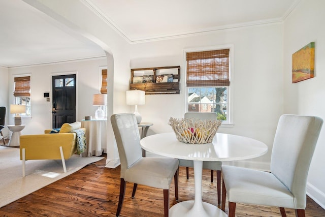 dining room featuring ornamental molding and hardwood / wood-style floors