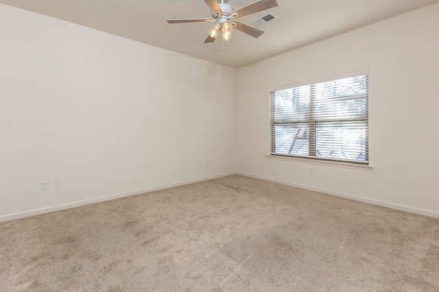 unfurnished room with ceiling fan and light colored carpet