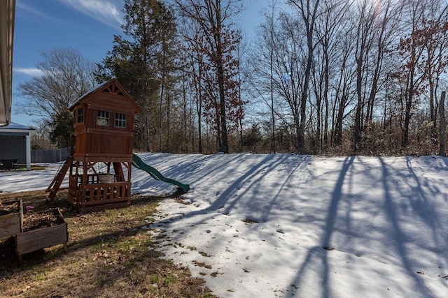 yard covered in snow with a playground